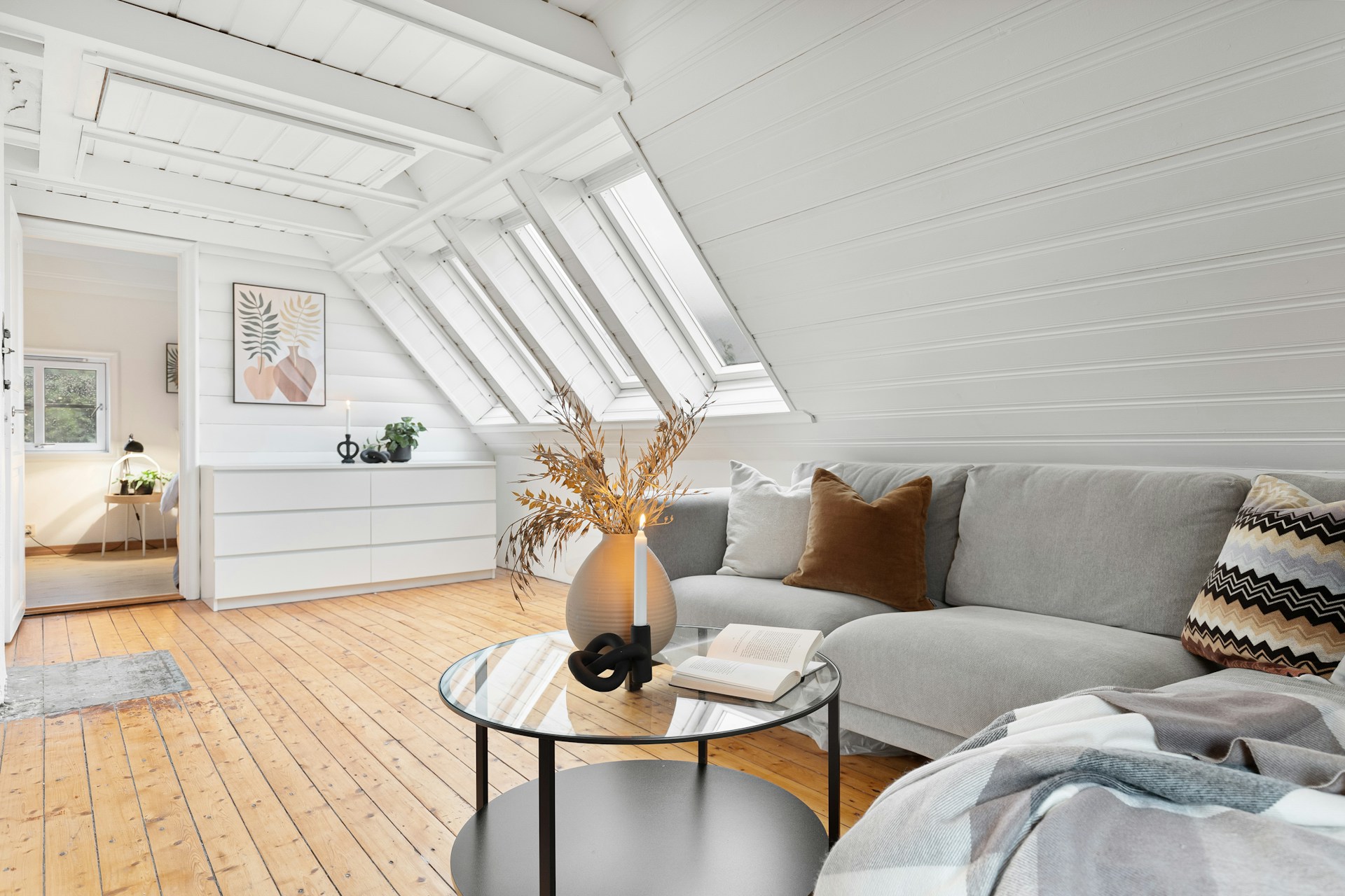 Scandinavian-style studio with white loft bed and metal accents