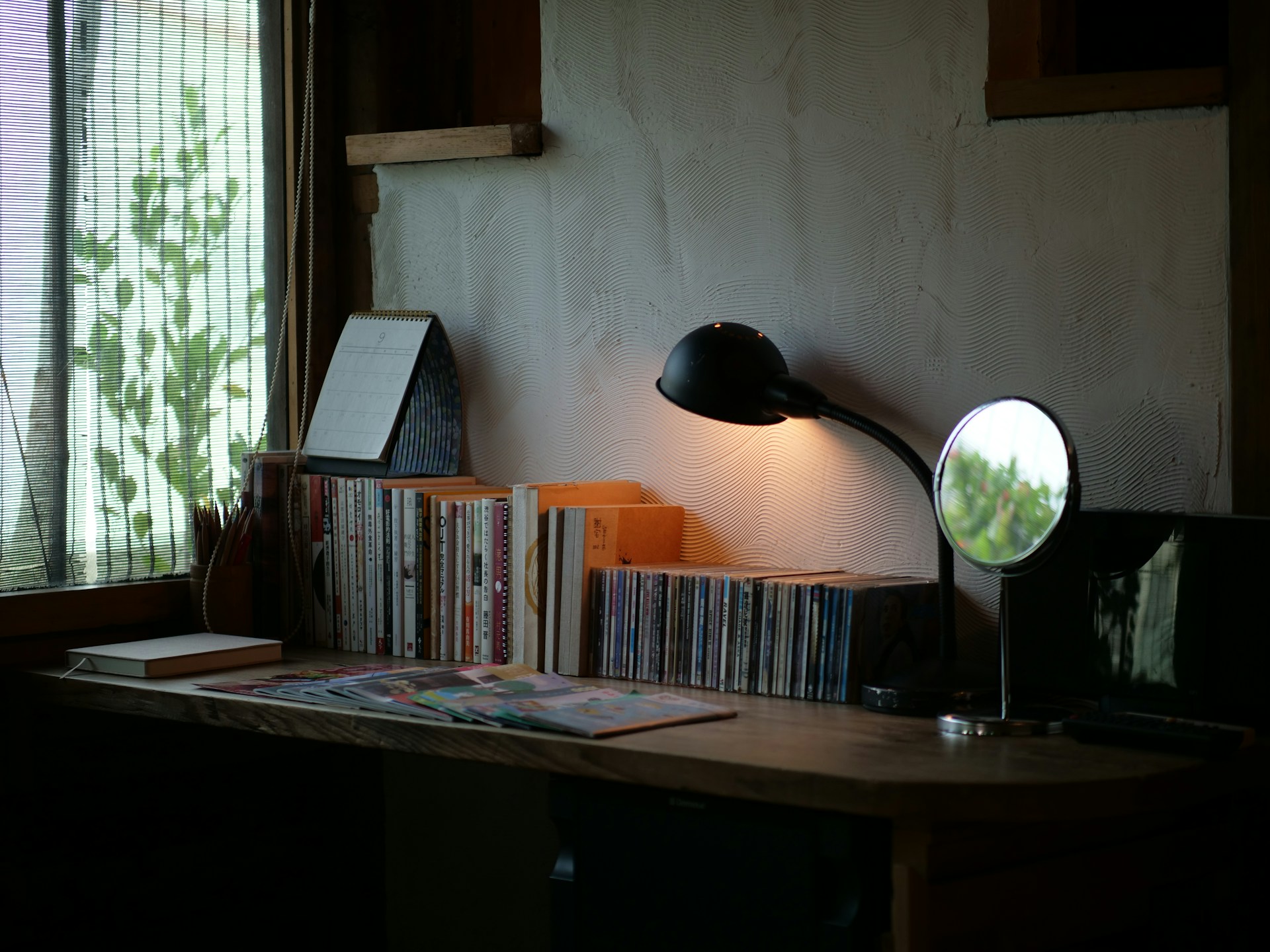 cozy corner with shelf and reading lamp in studio apartment