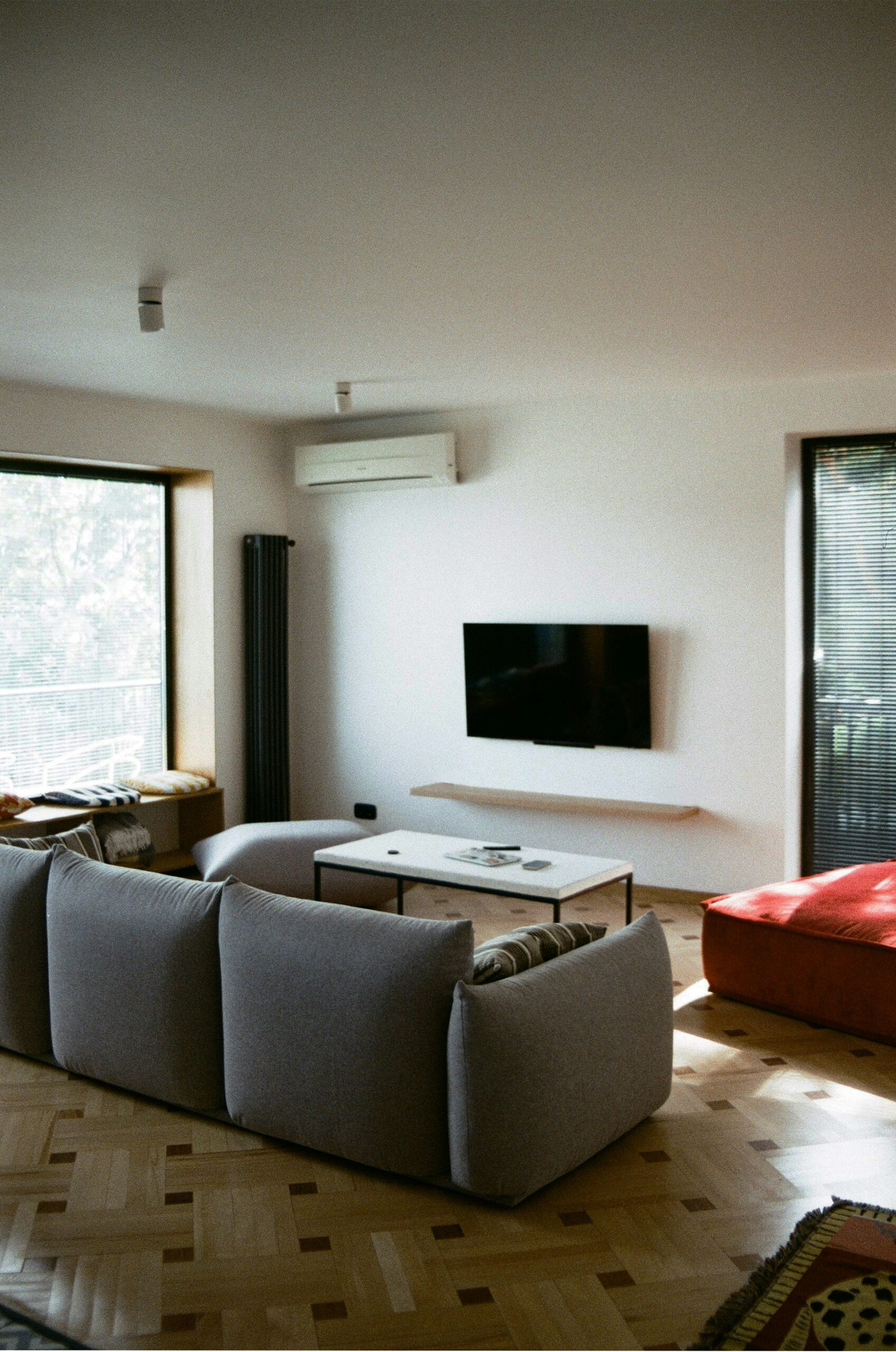 sofa used as room divider in open studio apartment layout